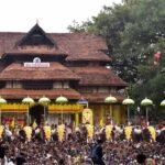 Decorative flags being hoisted at Thrissur temple marking the official start of Thrissur Pooram festival.