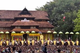 Decorative flags being hoisted at Thrissur temple marking the official start of Thrissur Pooram festival.
